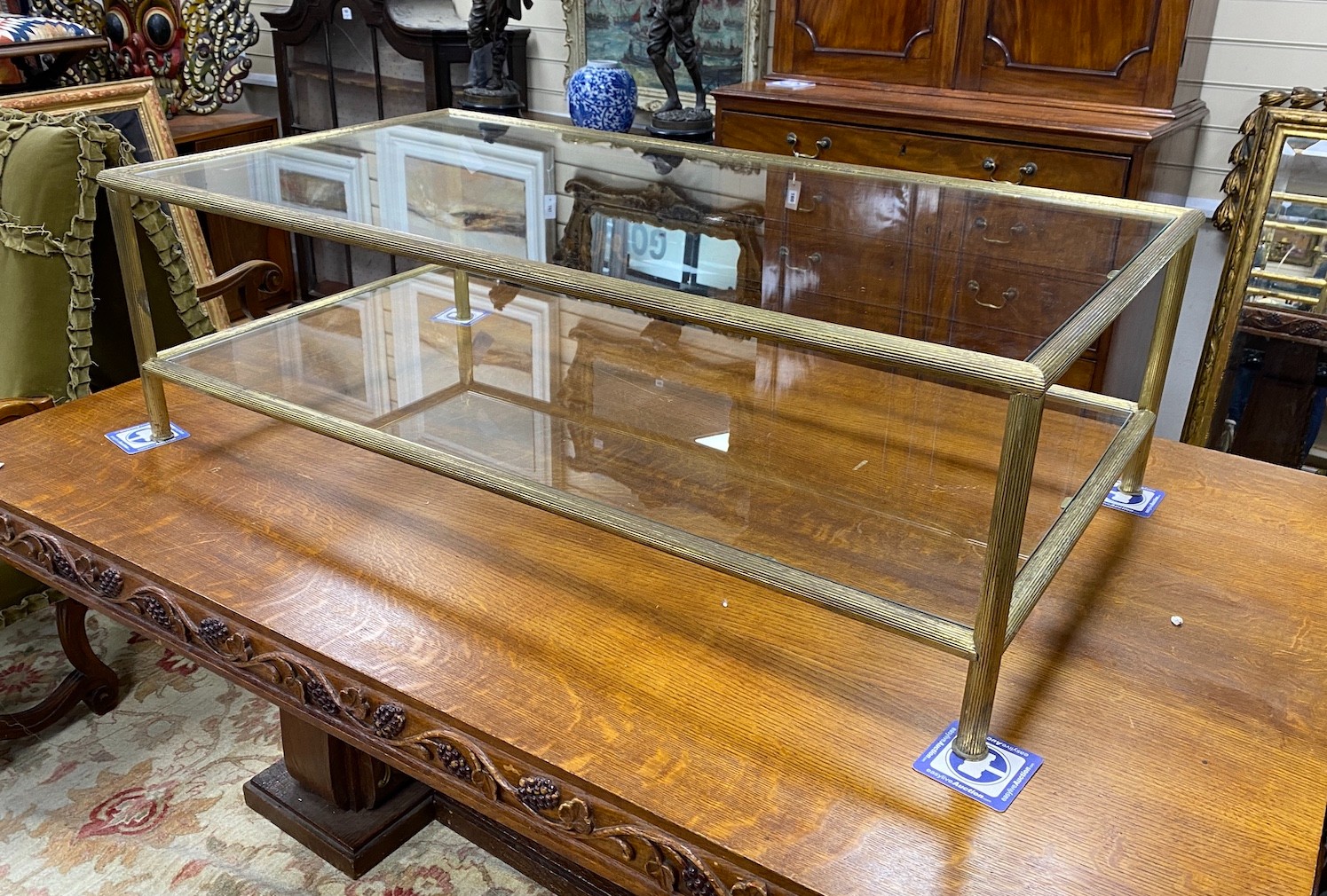 A Maison Jansen style rectangular glass and brass two tier coffee table, length 130cm, depth 70cm, height 41cm
